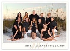 a group of people posing for a photo in the sand