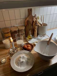 the kitchen counter is cluttered with cooking utensils, eggs and other ingredients