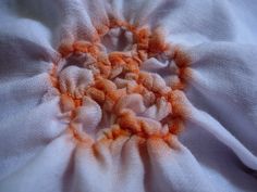 an orange and white flower is shown in this close up photo, with the center section visible