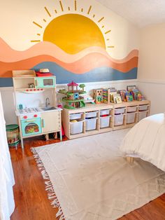 Minimalistic playroom with a bright and fun sun mural Playroom Paint Ideas, Sensory Playroom, Playroom Paint, Room Decor Ideas Aesthetic, Room Decor Bedroom Aesthetic, Aesthetics Room Decor, Playroom Mural, Neutral Kids Room, Indoor Playroom