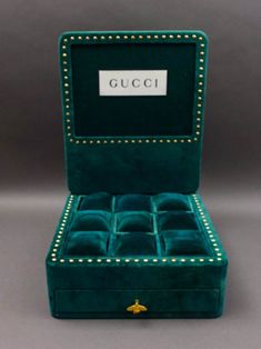 a green velvet jewelry box with gold trimmings