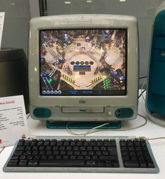 an old computer monitor sitting on top of a desk next to a keyboard and mouse