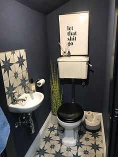 a black and white bathroom with blue walls