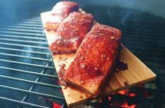 two pieces of meat cooking on a grill