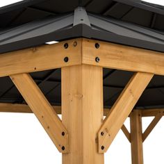 the top of a wooden structure with metal roofing and black shinning on it