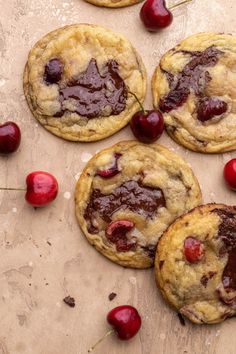 chocolate chip cookies with cherries on a table