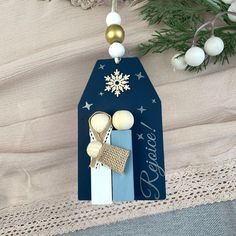 an ornament with two wooden spoons and a snowflake on it