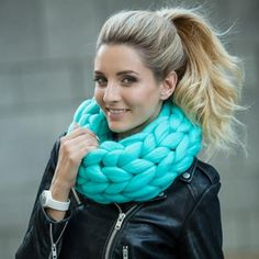 a woman with blonde hair wearing a blue scarf