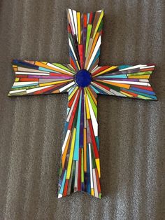 a cross made out of strips of colored paper