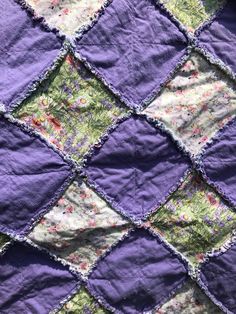 the quilt is made with purple and green fabric