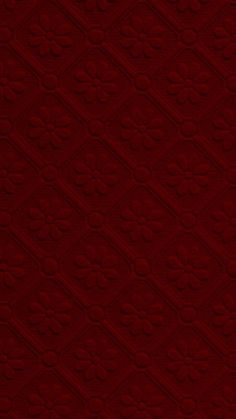 a red background with an intricate pattern on it's surface and the bottom half is slightly visible