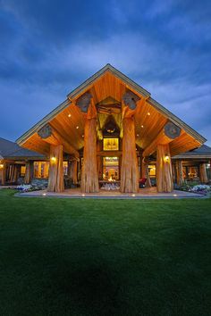 an instagram photo of a large house with columns in the front yard and lights on