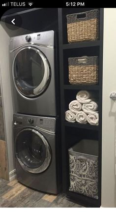 a washer and dryer sitting next to each other in a room with towels