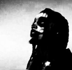 a black and white photo of a woman with dreadlocks