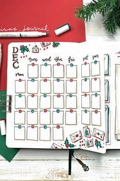 a planner with christmas decorations on it next to some markers and pencils in front of the calendar