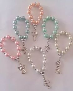 several bracelets with cross charms and beads