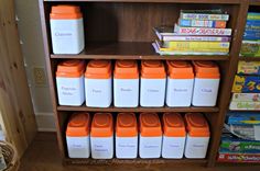 a book shelf filled with orange and white containers