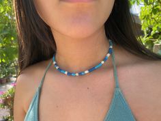 Dainty Surfer summer choker, beaded choker necklace, blue choker for women, surfer jewerly gift for women Dainty Surfer choker necklace style in blue color, with gold plated brass beads, white shell beads and polymer clay beads. In this list the choker is in blue color but is avalaible in other colors at my store. The diammeter of the beads is 4mm and the lenght of the choker is 35cms + 5 cms of extra chain. These simple, delicate and versatil choker that you can wear at any occassion. Confortab Trendy Blue Beaded Choker, Trendy Blue Beaded Necklaces For Festival, Trendy Blue Choker With Colorful Beads, Blue Beachy Necklace, Adjustable Blue Beachy Necklace, Blue Tiny Beads Choker For Summer, Turquoise Tiny Beads Choker For Beach, Summer Blue Beaded Choker, Trendy Blue Choker With Tiny Beads