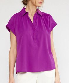 This lightweight top features a collared neckline, button down detail, short sleeves and permanent rolled cuffs. Easy to style for work or play, this top is versatile, comfortable and chic. 100% polyester Unlined, woven, non-sheer, lightweight Model is wearing a size small and is 5'10" Plum Top, Collared Top, Belted Midi Dress, Lightweight Tops, Collar Top, Sheer Top, Polished Look, Clothes Gift, Short Sleeve Top