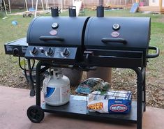 an outdoor bbq with two large grills on it