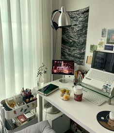 a white desk with a laptop computer on top of it and a cup of coffee in front of it