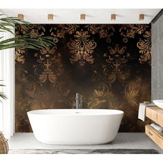 a bath tub sitting next to a sink in a bathroom under a window with gold wallpaper