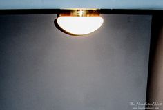 a light that is on the side of a wall in front of a lamp fixture