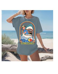 Dive into a sea of positivity with our "Stay Positive: Jaws Edition" Cotton Tee! This shirt combines a touch of humor with a wave of optimism as Jaws takes center stage, reminding you to face challenges with a smile. The vivid print features the iconic scene of Jaws and a floaty, creating a playful and encouraging vibe. Crafted from soft, comfortable cotton, this tee is a fin-tastic addition to your collection. Embrace the jawsome attitude and make a statement that encourages positivity in every stride. 🌊😄 *Unisex Sizing* Casual Short Sleeve Shark Design Tops, Casual Short Sleeve Top With Shark Design, Blue Surfing Tops With Screen Print, Casual Summer T-shirt With Shark Design, Funny Beach T-shirt With Crew Neck, Summer Short Sleeve Tops With Shark Design, Blue Surfing T-shirt For Beach Season, Blue Shark Design Crew Neck Top, Blue Shark Design Short Sleeve Tops