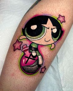 the powerpuff girl tattoo on the arm is very colorful and has stars around it