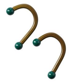 two metal hooks with green balls on them