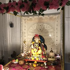 there is a small shrine with flowers on the table