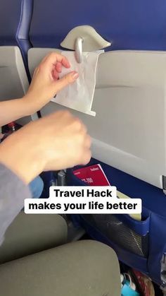 a person sitting in an airplane holding a piece of paper with the words travel hack makes your life better