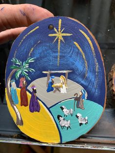 hand painted nativity scene displayed in glass window