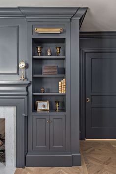 a living room with a fireplace and bookshelf next to it's doors