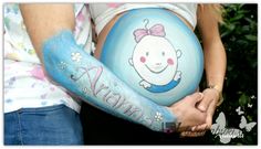 a pregnant woman holding her belly painted in blue and pink with the word always on it