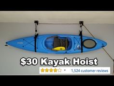 a blue kayak is hanging on the wall