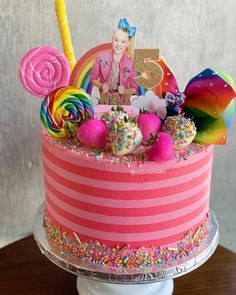 a birthday cake decorated with candy, candies, and an image of a woman