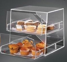 three tier acrylic display case with cupcakes and muffins in it