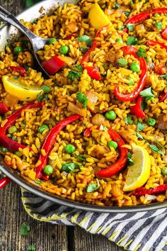 a pan filled with rice and vegetables on top of a table