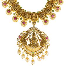 Designed with the elegance, this 22k antique gold Lakshmi necklace set by Virani Jewelers features rubies, emeralds, pearls and cubic zirconia stones. The antique gold finish offers a sophisticated, vintage look, while the gemstones add a vibrant contrast. Ideal for formal events and celebrations, this 22k gold Lakshmi necklace is a beautiful representation of traditional craftsmanship, blending heritage and contemporary style for those who appreciate luxurious, meaningful Indian jewelry.Features• 22k yellow gold• Antique finish• Engraved details• Emerald• Ruby • Pearl• Cubic zirconiaSpecifications:• Minimum Width - 2.5 millimeters• Maximum Width - 61.6 millimeters• Length - 30 inches• Weight - 111.7 grams Antique Finish, 22k Gold, Vintage Look, Indian Jewelry, Formal Event, Gold Finish, Vintage Looks, Antique Gold, Necklace Set