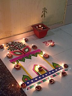 diwali decoration on the floor with lit candles