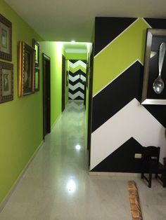 the hallway is decorated in black, white and green colors with an interesting chevron pattern