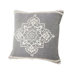 a gray and white pillow with an intricate design on the front, sitting on a white background