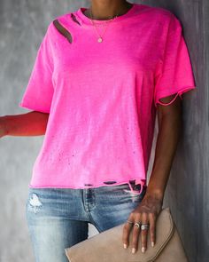 It's no joke with the Game On Cotton Distressed Tee! We've got a lightweight. heathered neon pink tee that sports a relaxed fit and semi cropped length. Cut with a crew neckline and short sleeves and moderate distressing! Finished with an unfinished hemline and sleeve hems to achieve the ultimate look. An edgy basic to style for summer + pre-fall! Styled with the Chloe Mini Necklace. Bali Necklace. Austin Distressed Skinny. Make A Scene Heels and Stella Crossbody Envelope Zip Clutch. Relaxed Fit Ripped Short Sleeve T-shirt For Summer, Pink Distressed Casual T-shirt, Casual Pink Distressed T-shirt, Ripped Relaxed Fit Short Sleeve T-shirt, Pink Distressed Summer T-shirt, Pink Distressed T-shirt For Summer, Pink Distressed Cotton Tops, Sporty Soft-washed Pink Tops, Trendy Distressed Pink Top