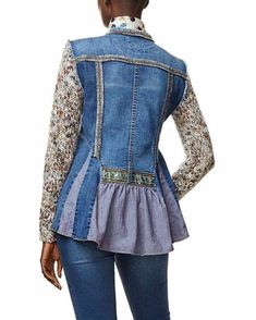 a woman is wearing a jean jacket with floral print on the sleeves and hems