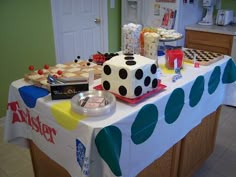 a table covered with cakes and desserts in the shape of dices on it