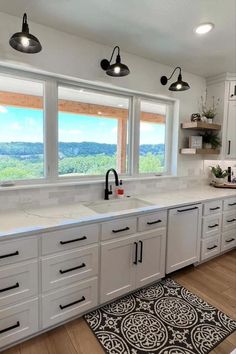 Enter the realm of contemporary elegance within a black and white kitchen boasting streamlined white cabinetry, striking black hardware, and a pristine white marble countertop. At the heart of this design, a large ceramic sink, accompanied by a black gooseneck faucet, takes center stage.

Light wood floating shelves, embellished with greenery and modern accents, frame a spacious kitchen window, creating a captivating interplay of light and shadow. Light Wood Floating Shelves, Light Wood Shelves, Farmhouse Kitchen Sink Ideas, Black Sink Kitchen, Kitchen Decor Ideas Diy, Cheap Kitchen Makeover, Farmhouse Kitchen Decor Ideas, Kitchen Sink Ideas, Kitchen Sink Countertop