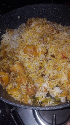 a pan filled with food sitting on top of a stove