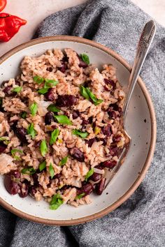 a white bowl filled with rice and beans