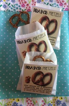 three packages of pretzels sitting on top of a blue and white table cloth